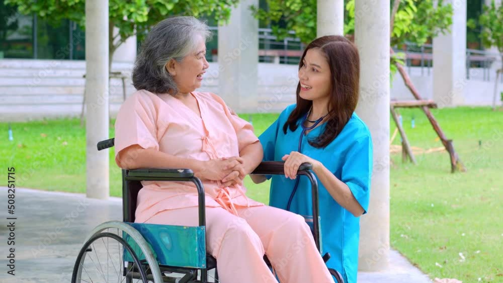 Asian careful caregiver or nurse taking care of the elderly Asian patient in a wheelchair. Concept of happy retirement with care from a caregiver and Savings and senior health insurance. elderly care Asian careful caregiver or nurse taking care of the elderly Asian patient in a wheelchair. Concept of happy retirement with care from a caregiver and Savings and senior health insurance. elderly care