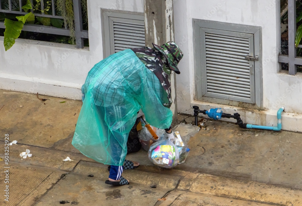 A cleaning worker collects garbage on the street