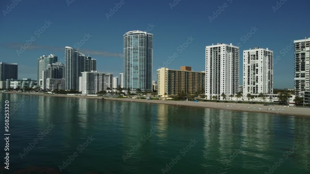 Aerial view of condos, apartment buildings and hotels with ocean views. The water is flat, calm on this tranquil day showing off this excellent South Florida tourist destination. Aerial view of condos, apartment buildings and hotels with ocean views. The water is flat, calm on this tranquil day showing off this excellent South Florida tourist destination.