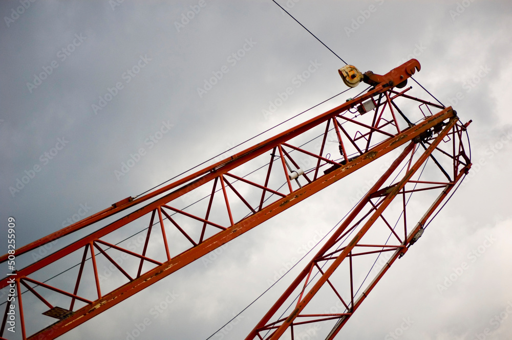 Large construction site crane working on a building complex. Large construction site crane working on a building complex.