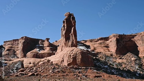Driving past Sheep Rock in Arches National Park during the day