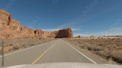 Driving towards the Great Wall in Arches National Park during the day, POV