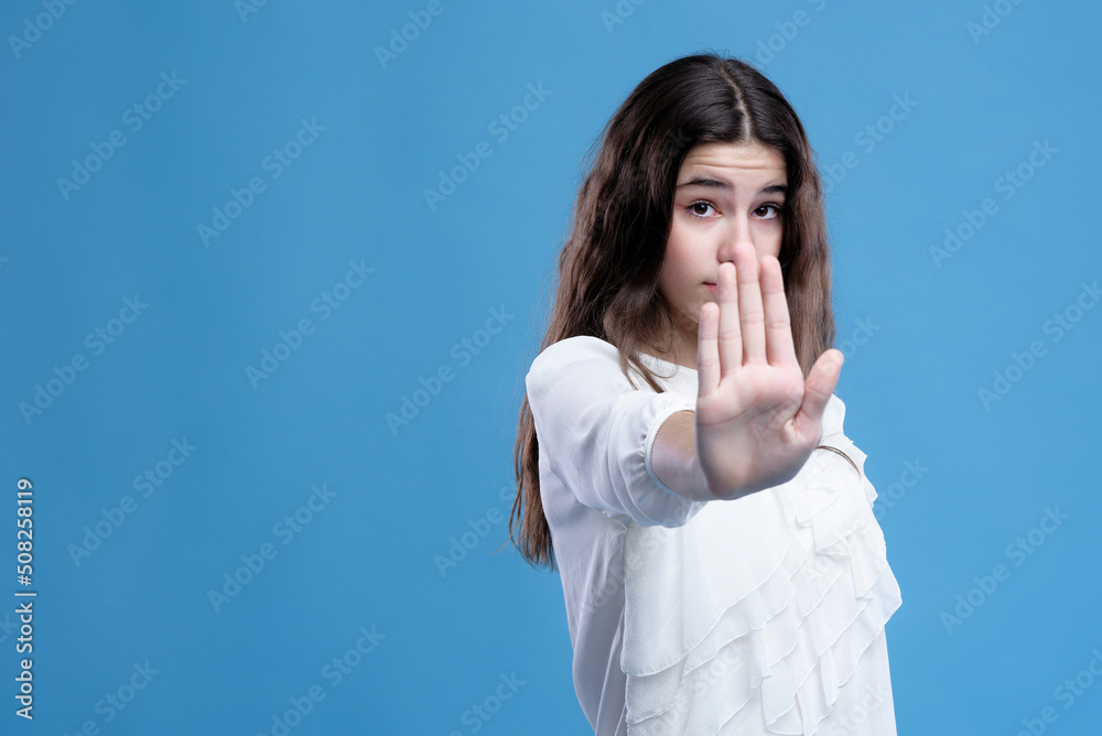 Angry teenage girl telling you to stop and not come closer to her Angry teenage girl telling you to stop and not come closer to her
