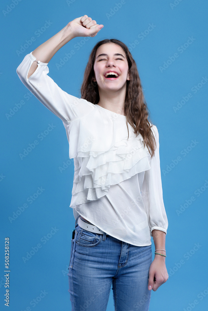 Happy young teenage girl, making a victory gesture Happy young teenage girl, making a victory gesture