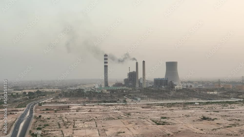 Aerial of factory in jamshoro Pakistan during sunset time. Drone around toxic enterprise chimneys tubing. Aerial of factory in jamshoro Pakistan during sunset time. Drone around toxic enterprise chimneys tubing.