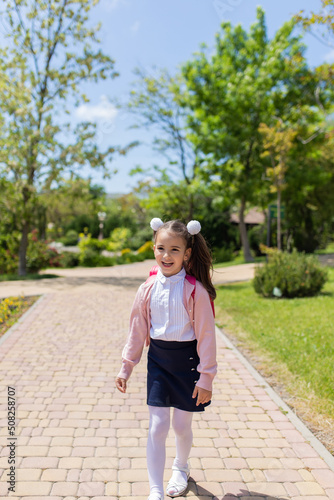 Back to school. Happy smiling kid go to elementary school. Child with school bag outdoors © яна винникова