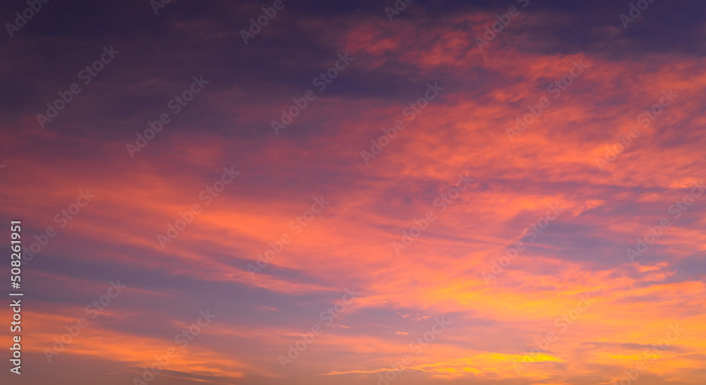 Colorful sunset sky clouds in the evening with red, pink, and purple sunlight on dusk 