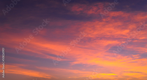 Colorful sunset sky clouds in the evening with red, pink, and purple sunlight on dusk 