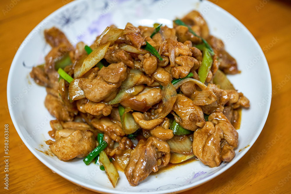 A delicious Chinese home-style dish, fried chicken thighs in Beijing green onion sauce A delicious Chinese home-style dish, fried chicken thighs in Beijing green onion sauce