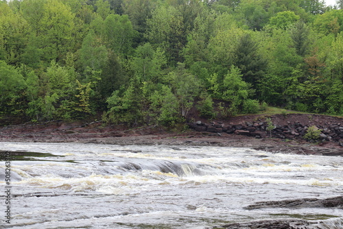 Cascades and river. Flowing and stream on a river. Littles waterfalls in spring and summer. Adventure and hiking. Tourism in Quebec. Cascades background.