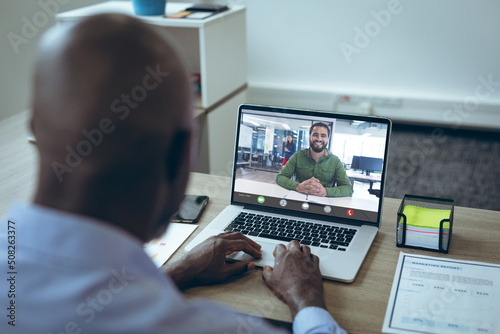 African american businessmen having online meeting though laptop in office