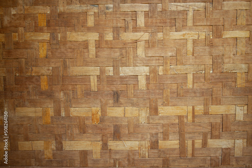 The background wall of the house is made of woven bamboo.