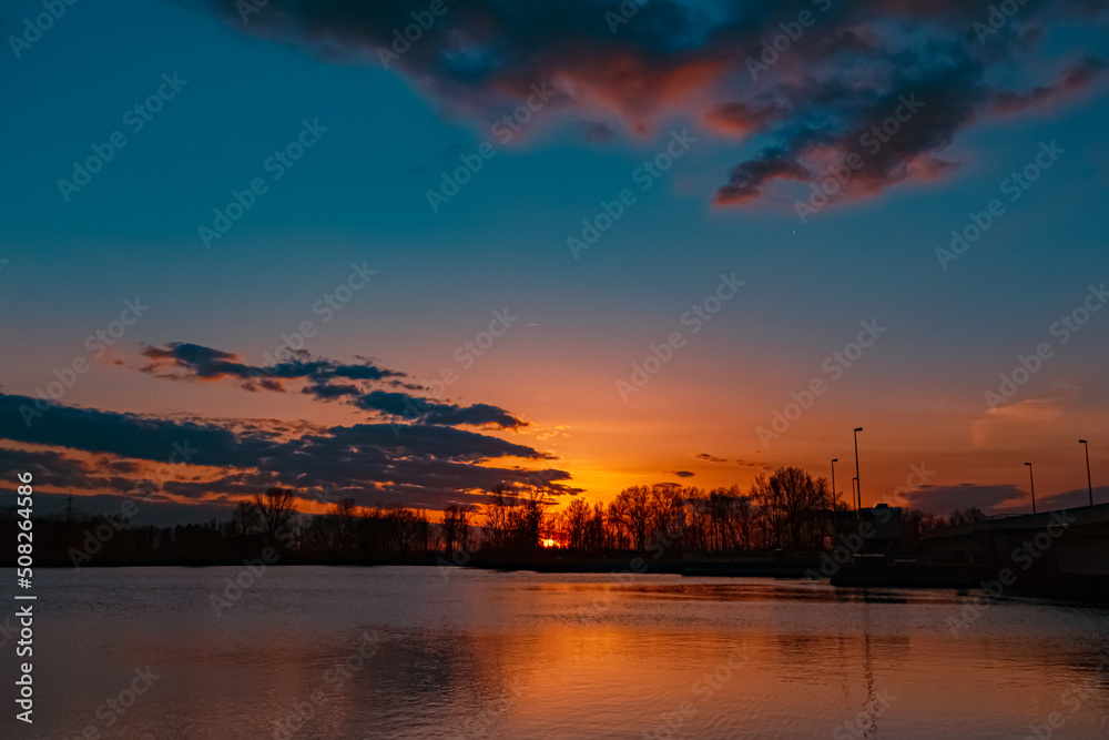 Fototapeta premium Beautiful sunset view with reflections near Plattling, Isar, Bavaria, Germany