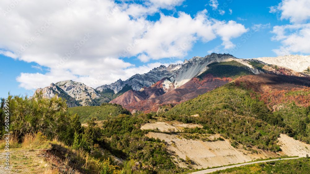 Snowy hills in autumn with a forest of many colors. Route 40. Bariloche, Argentina