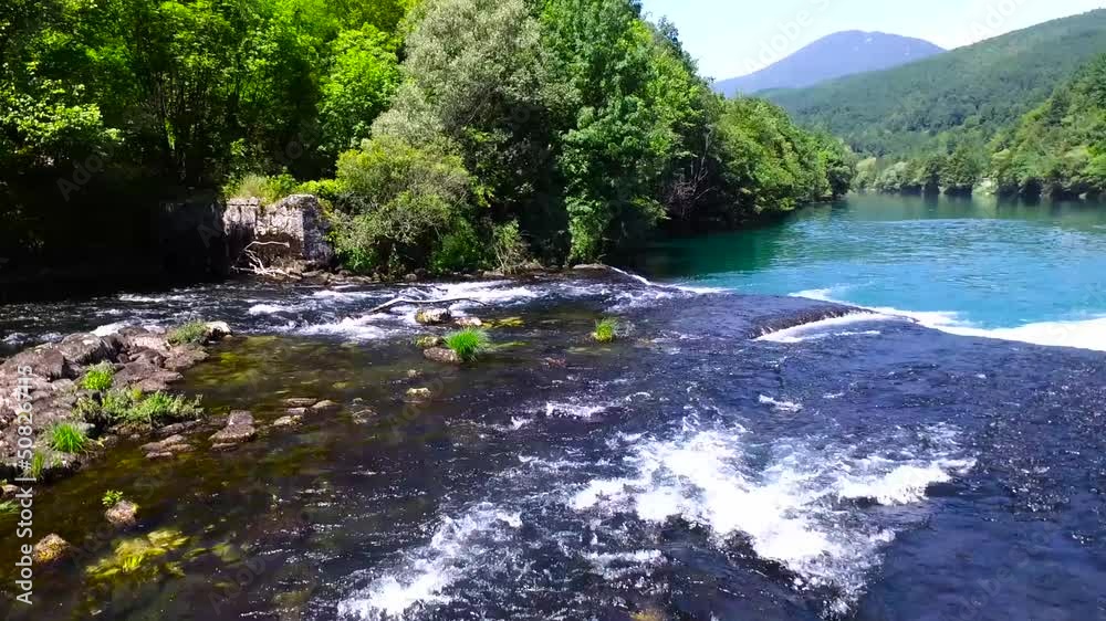 Aerial shot of a beautiful clear turquoise river Una with its waterfalls, Bosnia and Herzegovina Aerial shot of a beautiful clear turquoise river Una with its waterfalls, Bosnia and Herzegovina