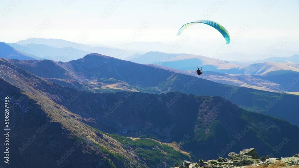 Paraglider take off and flight in breathtaking mountains