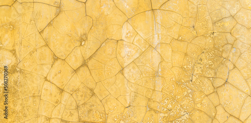 Old crack yellow cement wall texture background well editing text present on free space backdrop