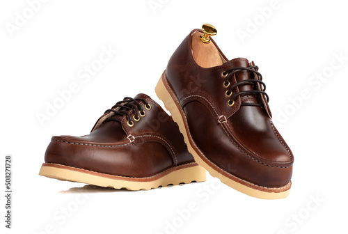 Men fashion brown shoes leather with shoe tree (shape supporter) isolated on white background. Clipping path
