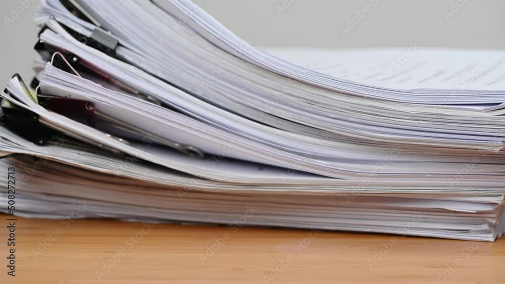 Businessman are searching for documents lying on the table, business report papers, important documents. Businessman are searching for documents lying on the table, business report papers, important documents.