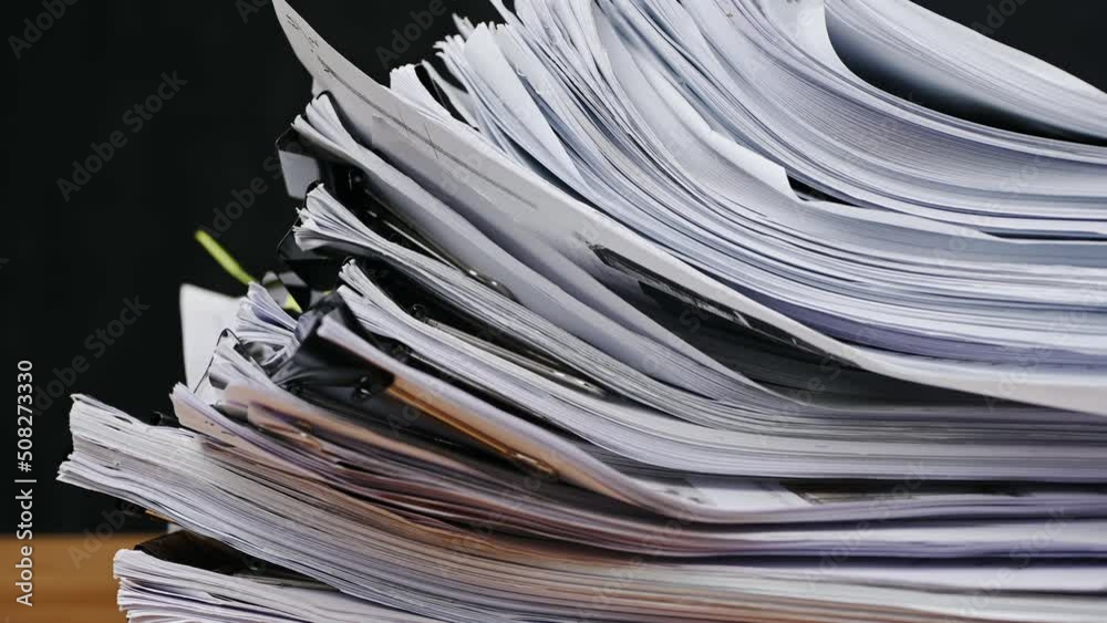 Businessman are searching for documents lying on the table, business report papers, important documents. Businessman are searching for documents lying on the table, business report papers, important documents.