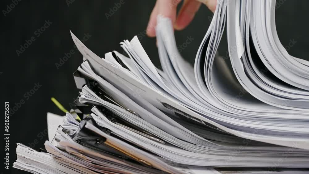 Businessman are searching for documents lying on the table, business report papers, important documents.