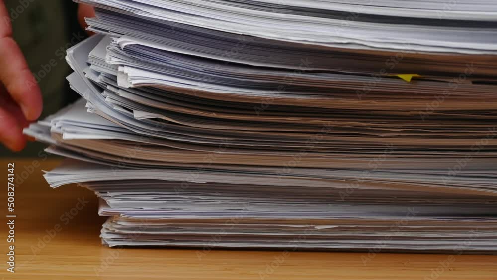 Businessman are searching for documents lying on the table, business report papers, important documents. Businessman are searching for documents lying on the table, business report papers, important documents.
