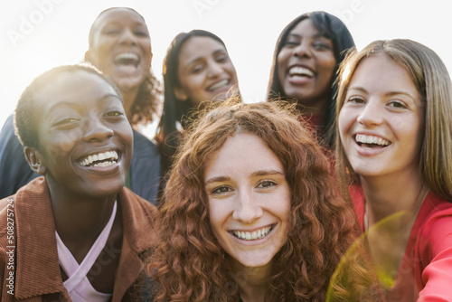 Fotografija Multiethnic young women having fun together doing selfie outdoor - Focus on ging