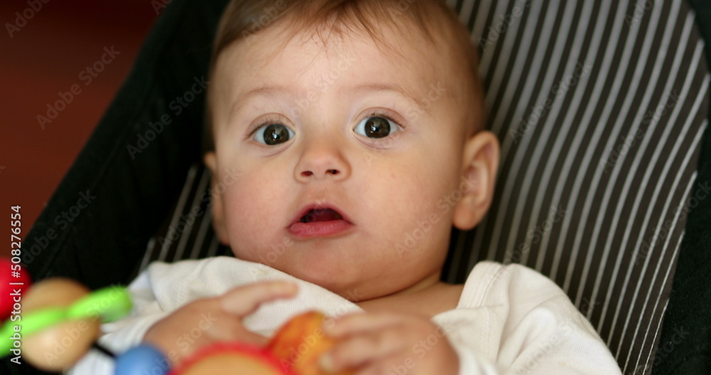 Cute baby eating apple fruit. Infant boy eats healty snack Cute baby eating apple fruit. Infant boy eats healty snack