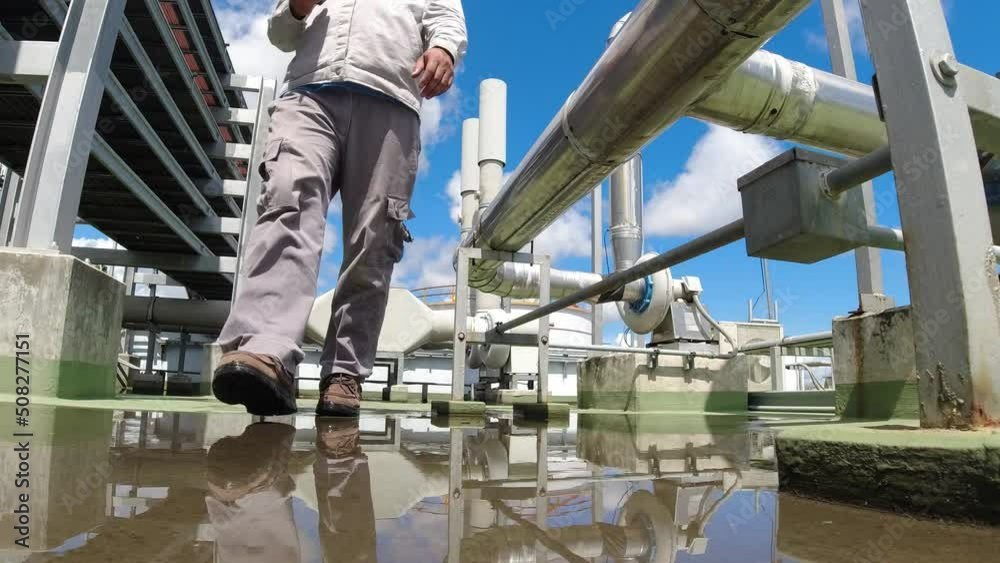 Engineer in a hard hat and safety uniform. The air conditioning system