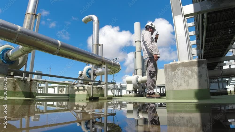 Engineer in a hard hat and safety uniform. The air conditioning system