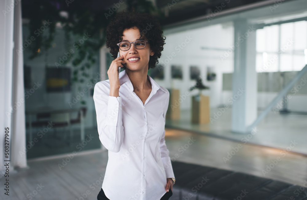 Business woman talking on smartphone in office Business woman talking on smartphone in office