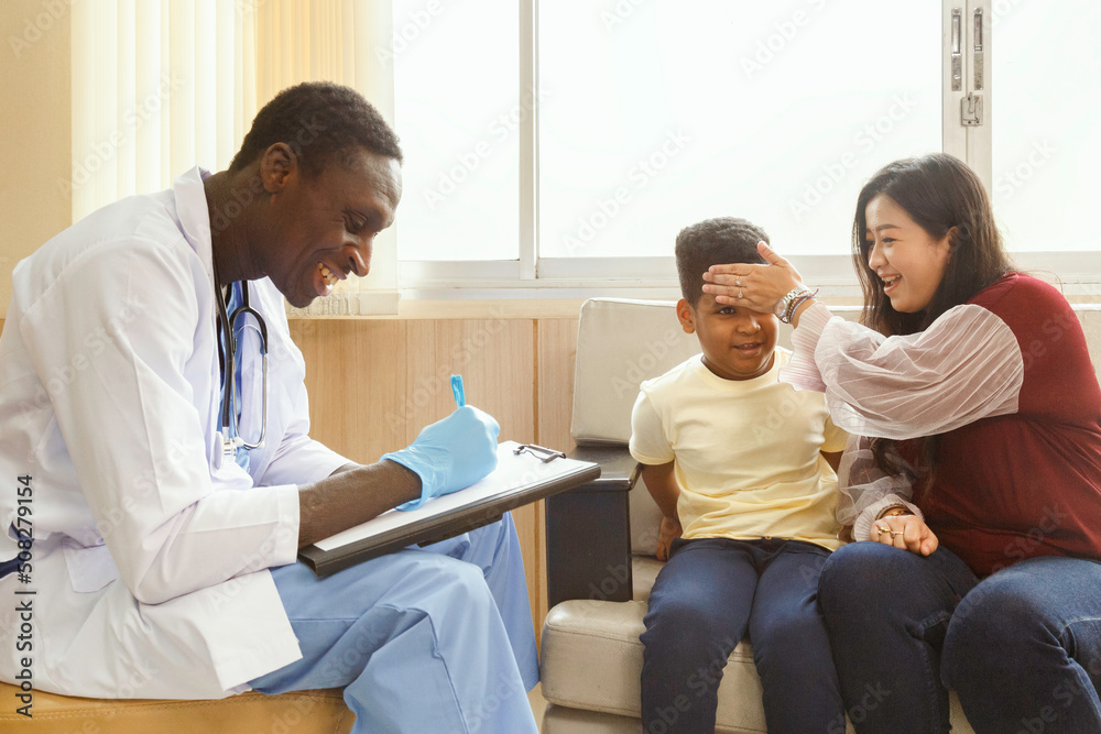 family psychologist. asian mother and her boy talk to african american psychotherapist doctor during therapy session at the hospital. family psychologist. asian mother and her boy talk to african american psychotherapist doctor during therapy session at the hospital.