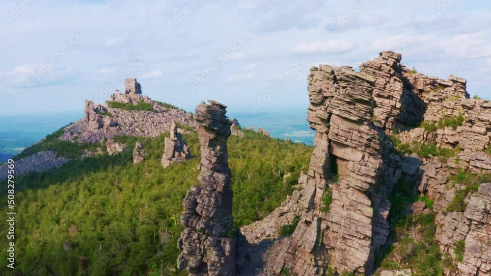 Rocks in the mountains in the middle of a dense green forest. Beautiful natural landscape. Aerial view Rocks in the mountains in the middle of a dense green forest. Beautiful natural landscape. Aerial view