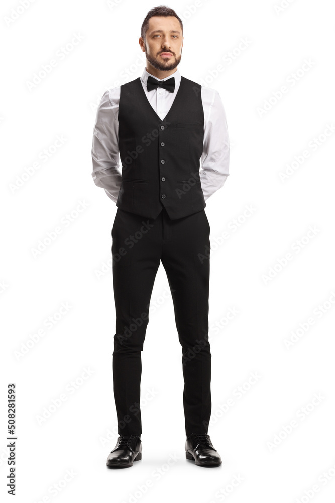 Full length portrait of a professional waiter with a bow tie and vest Full length portrait of a professional waiter with a bow tie and vest