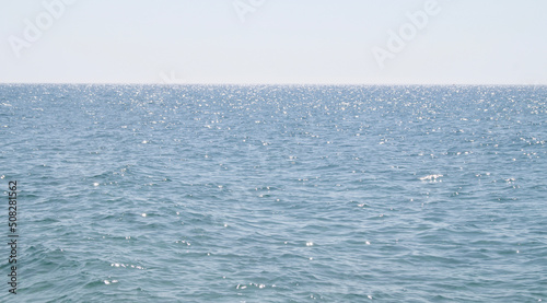 Bright sea. Wonderful background of the ocean. Space for text. Beach background. Shining ocean.