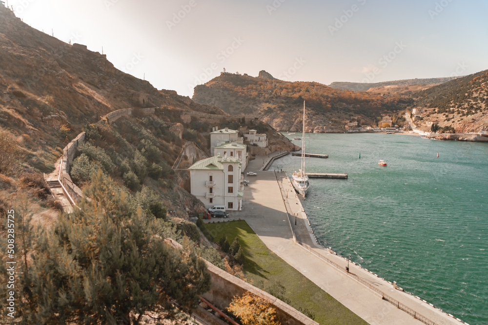 Overlook of Balaklava Bay with houses on the shore and yacht