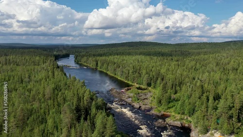 Aerial shot of Yama (Pit) rapid with catamaran in it and tourist camp on the bank of Tuntsayoky river on sunny summer day. Murmansk Oblast, Russia. photo