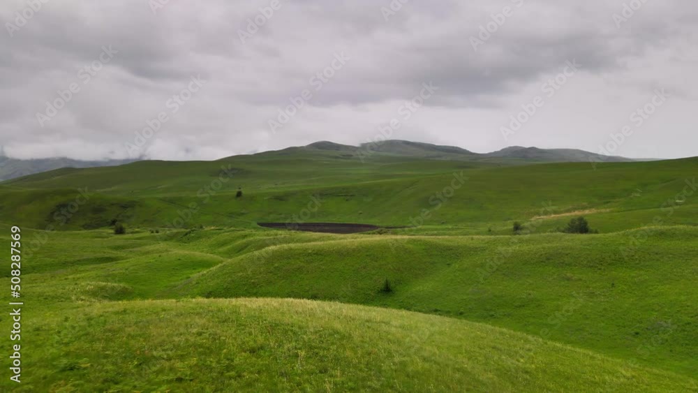 landscape with green grass and clouds landscape with green grass and clouds