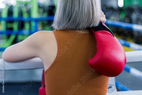 Back view boxer woman with boxer glove in gym © Jack Tamrong