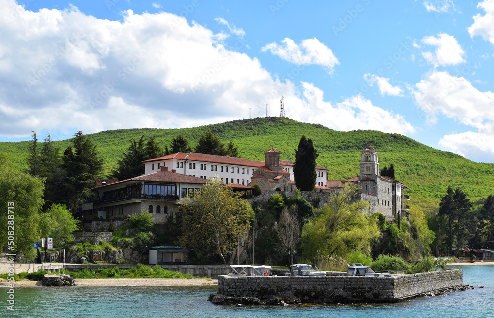 Orthodox monastery of St. Naum, which stands on a hill in Lake Ohrid. Green hilly mountains in North Macedonia.