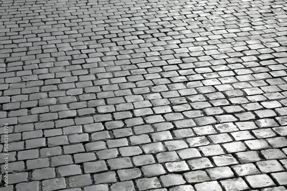 background of many cubic tiles called Sampietrini typical of the pavement of many European squares and especially of St Peter Square