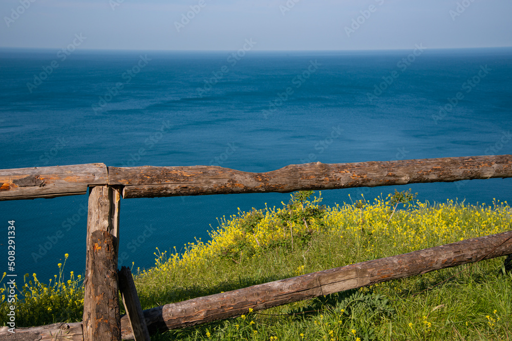 Wooden fence made of beams on top of a mountain overlooking the sea. Wooden fence made of beams on top of a mountain overlooking the sea.