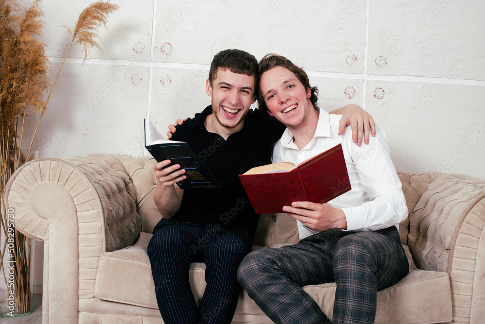 Young attractive gay couple is relaxing and reading books. Young attractive gay couple is relaxing and reading books.