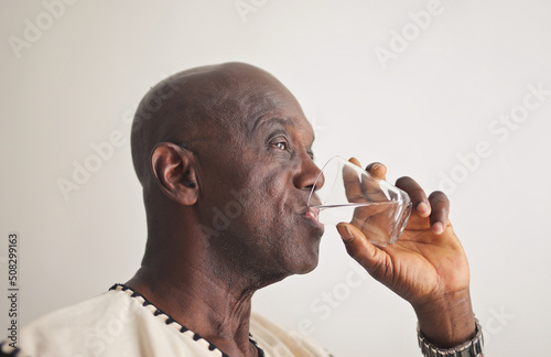 mature black man drinks water