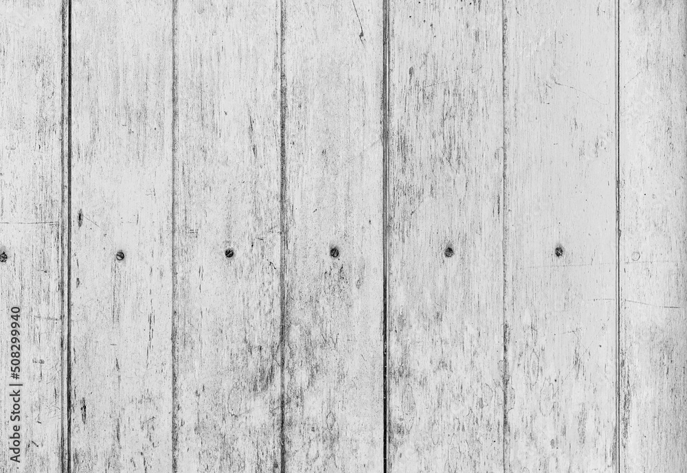 Texture of stained vertical planks facade. Old dirty rough siding of gnarled surface rural country wooden paneling. Messy aged laths.  Rustic grungy ranch lumber fence of hard boards for barn design