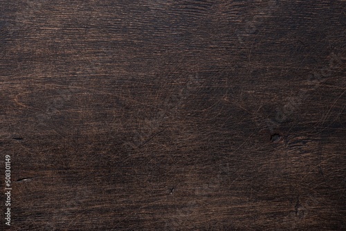 The old wooden background is dark brown with scuffs and scratches. View from above. Space for text.