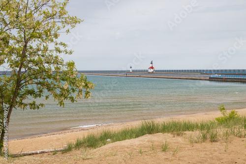 Sand beach and beachgrass with St. Joseph North Pier Inner Lighthouse and St. Joseph North Pierhead Outer Lighthouse, Michigan in background