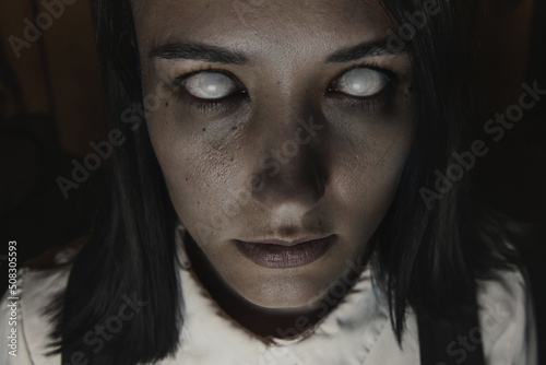 Female zombie staring into camera, close-up portrait
