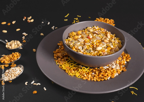 Bhel puri namkeen Chaat savoury snack served in a bowl isolated on dark background side view of nimko muri photo