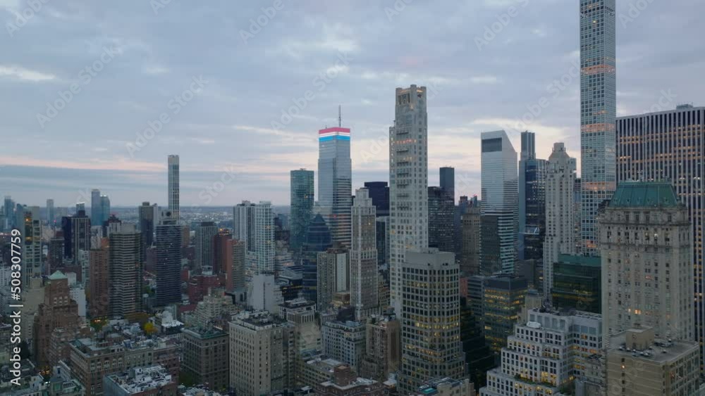 Backwards descending view of buildings in city centre at dusk. High rise buildings around Central park. Manhattan, New York City, USA Backwards descending view of buildings in city centre at dusk. High rise buildings around Central park. Manhattan, New York City, USA